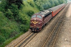 DSB MY 1136 heading for Vejle. Photographed in Fredericia May 1975.   The MY class was built by Nydquist & Holm AB (NOHAB) in Sweden licensed by General Motors. Danish subsuppliers (Frichs and Thrige) took part in the production. A1A-A1A. Dieselelectric. MY 1101 - 1105 was supplied with a General Motor 16-cyl. diesel engine performing 1.700 hp. The diesel engine in MY 1106 - 1144 was performing 1.950 hp - MY 1145 - 1159 1700 hp. Max speed 133 km/h - 83 mph. Length 18 900 mm. Weight 101,6 metric tonnes. MY 1136 was put in service in 1957. It was taken out of service in 1986 and scrapped in 1987.